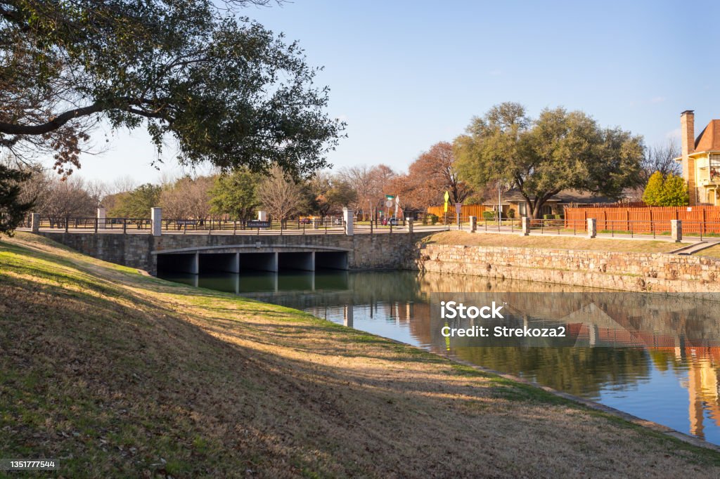 Bridge over the water channel in urban area Cross Bend Rd bridge over the water channel in Plano, Texas Plano - Texas Stock Photo