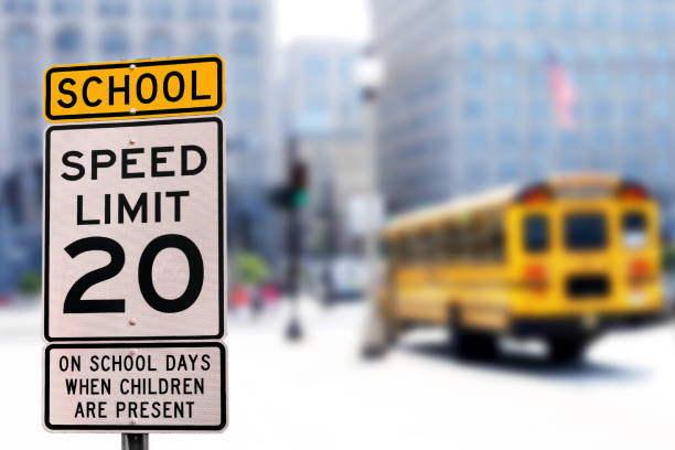 Traffic sign.  School zone  yellow warning board. Speed limit 20 Traffic sign.  School zone  yellow warning board. Speed limit 20 city street street corner tree stock pictures, royalty-free photos & images