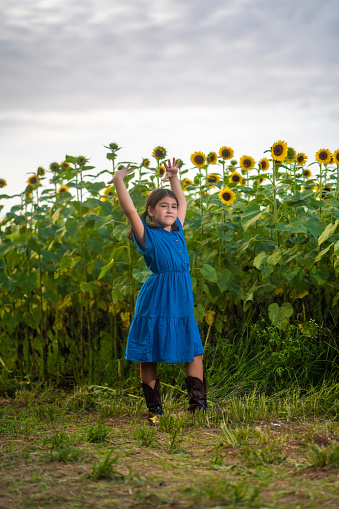 Little cuban ballet dancer on a sunflower field