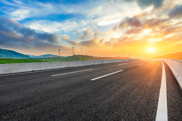 istock Empty asphalt road and mountain at sunset 1351781167