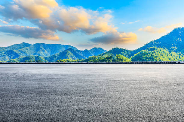 istock Empty asphalt road ground and mountain at sunset 1351782009