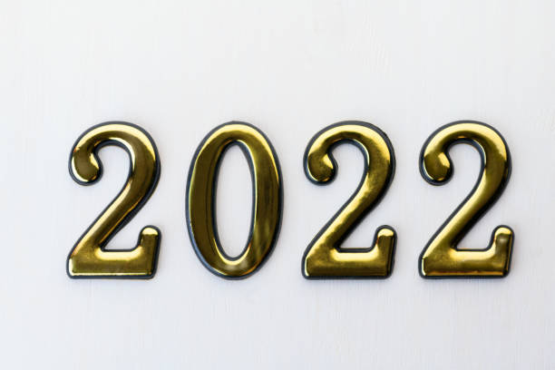 istock Blurred background. Numbers 2022 on white wooden background. Abstract new year backdrop with 2022 year 1351782795