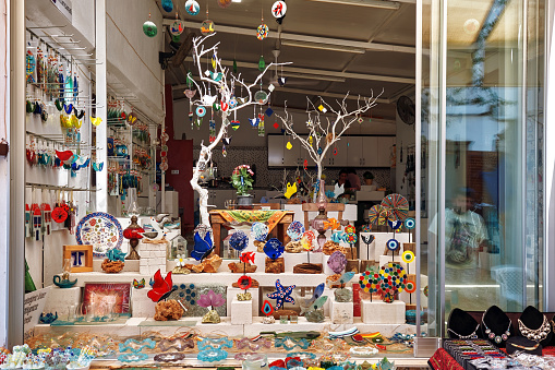 July, 2021 - Urla, Turkey: Showcase of a souvenir shop with decorative trinkets in Urla, Izmir, Turkey.