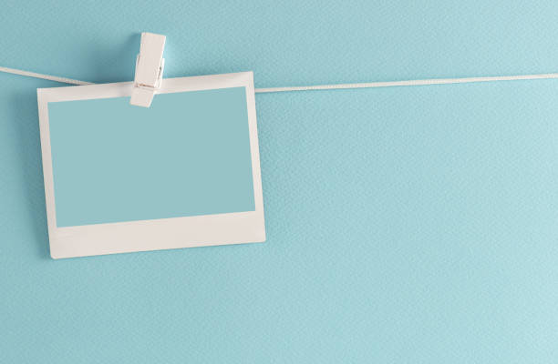 Photo Frame on a Clothesline Photo frame on a clothesline, blue background. clothesline photos stock pictures, royalty-free photos & images
