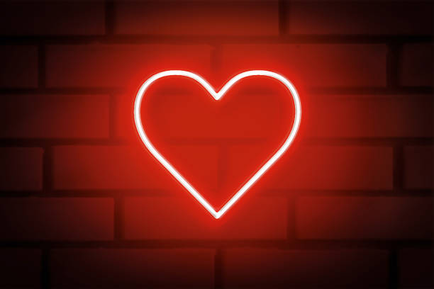 istock Heart shaped neon sign on brick wall 1351786597