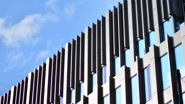 istock Modern office building with glass facade on a clear sky background. 1351786608