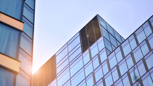 istock Modern office building with glass facade on a clear sky background. 1351786666