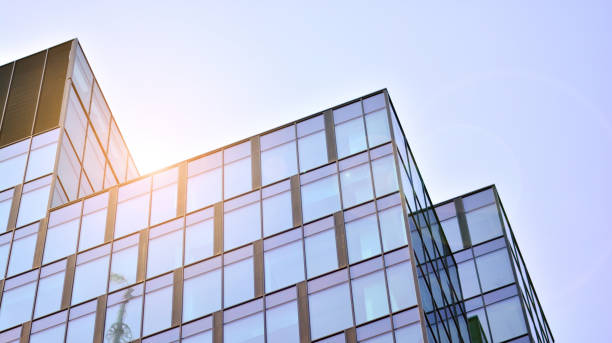 istock Modern office building with glass facade on a clear sky background. 1351786782