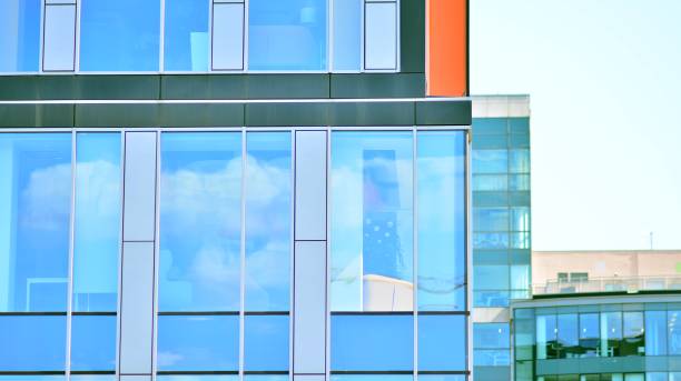 istock Modern office building with glass facade on a clear sky background. 1351787722
