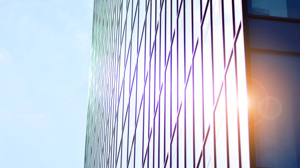 istock Modern office building with glass facade on a clear sky background. 1351787754