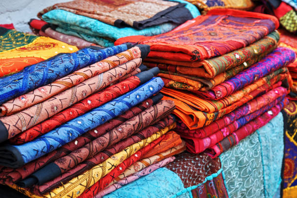 istock Authentic oriental colorful table clothes displayed at the counter. 1351787865