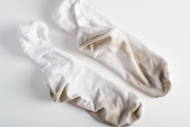 White socks soiled, dirty lying on clean surface indoors, top view stock photo