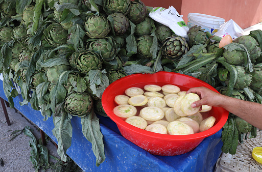 Bunch of fresh artichoke on traditional food market stall in Bologna, Italy