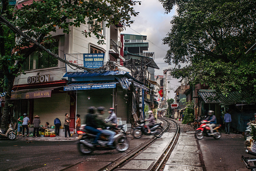 Hanoi, Vietnam - November 26, 2018: Crossroad at famous touristic place, railway through the narrow street Trần Phú