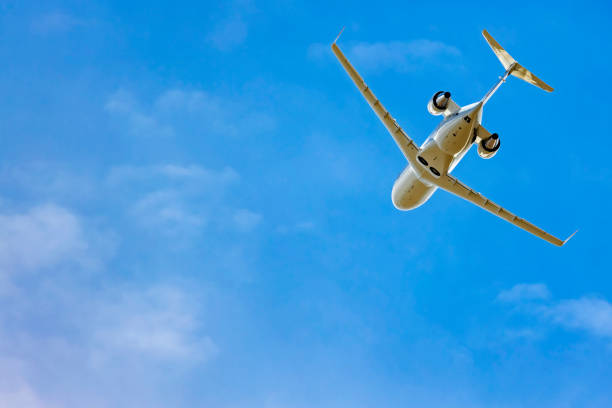 istock Corporate jet airplane taking off with blue sky 1351788890