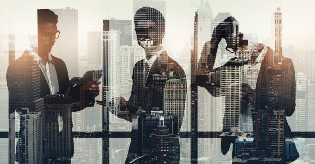istock Portrait of young businessmen using digital tablets superimposed over a cityscape 1351793607