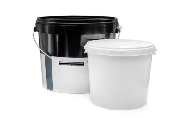 istock Two plastic bucket with putty and paint on white background. 1351799547