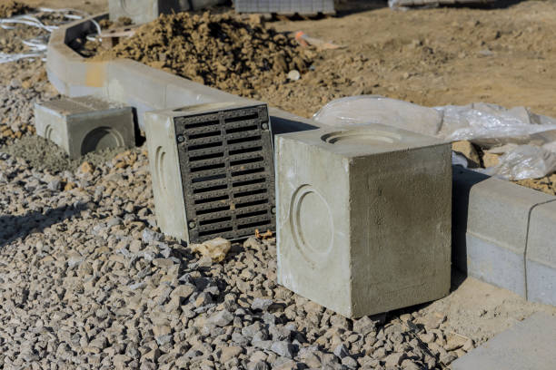 istock Construction site laying of water drainage storm sewerage concrete wells during construction road 1351801578