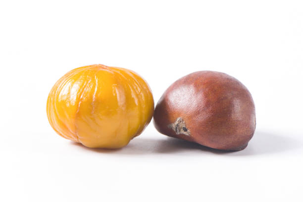 istock Close-up Chestnuts with peeled  isolated on white background. 1351801692
