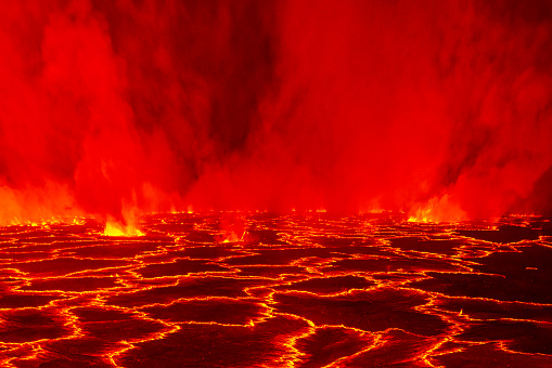 Lava lake night close-up view with incandescent and splashing lava