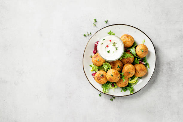 chickpeas falafel balls Vegetarian chickpeas falafel balls with fresh green salad. Traditional Middle Eastern and arabian food. Top view kosher starter recipes stock pictures, royalty-free photos & images