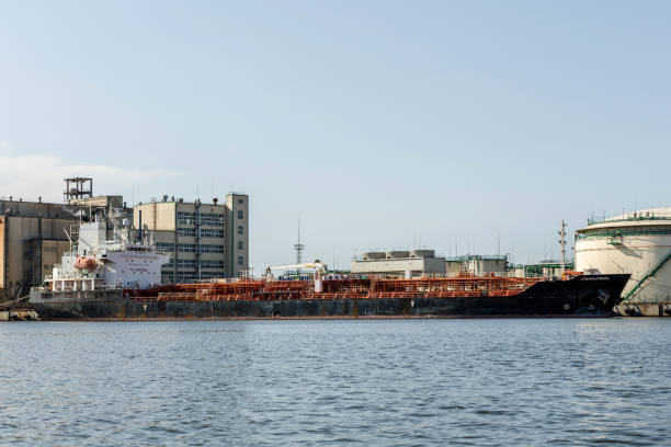 istock cargo ship on the river bank next to industrial facilities 1351805443