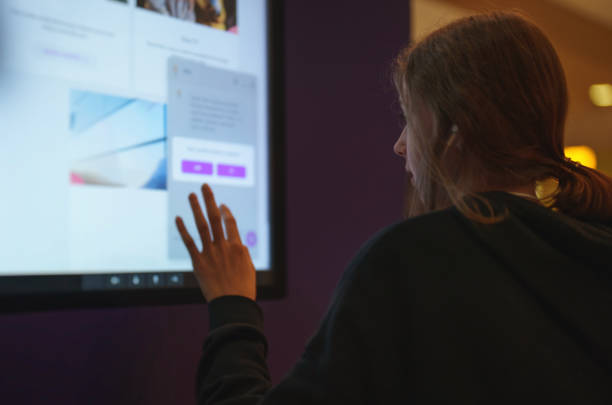 istock Teenage girl using touch screen display. 1351809466