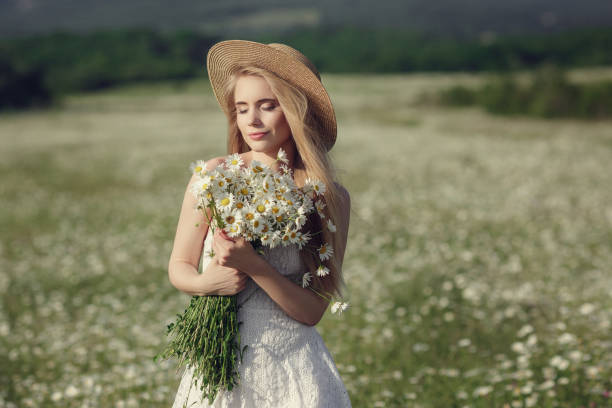 istock Beautiful woman enjoying daisy field 1351809792