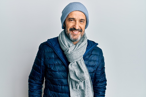 Middle age hispanic man wearing winter style with a happy and cool smile on face. lucky person.