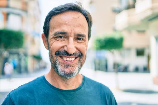 istock Middle age man with beard smiling happy outdoors 1351810681