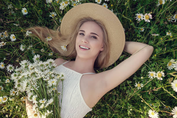 istock Beautiful woman enjoying daisy field 1351810771