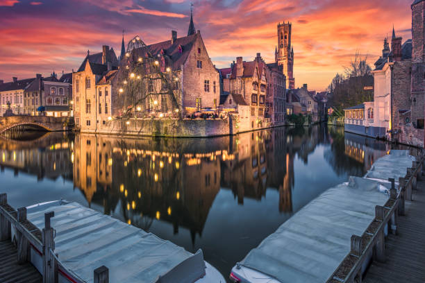 Historic medieval buildings along a canal in Bruges during amazing sunset, Belgium stock photo