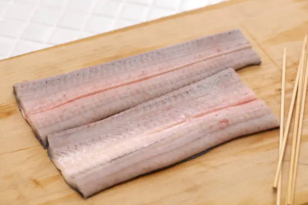 Preparing Japanese Unagi(eel) dishes; Putting the eel on skewers.
