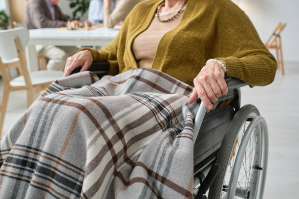 istock Woman with disability using wheelchair 1351817684