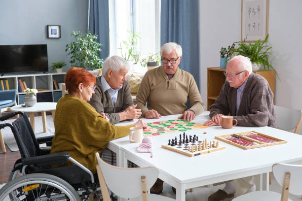 istock Senior people playing board games 1351817730
