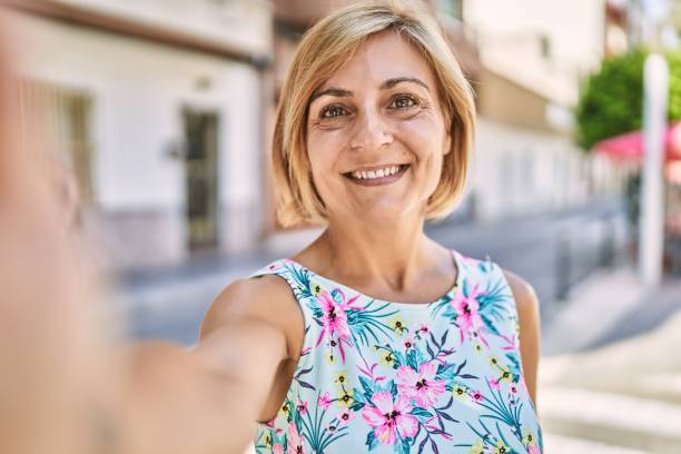 istock Middle age beautiful woman smiling confident at park 1351824465