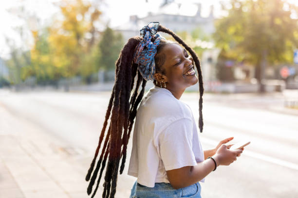 istock Attractive young woman using her smartphone outdoors 1351828191