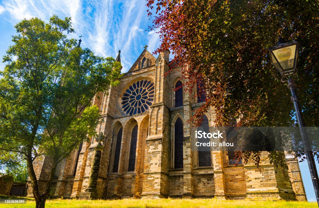 External view of Durham cathedral medieval religious building Sunshine illuminates the outside of Durham cathedral Architectural Column Stock Photo
