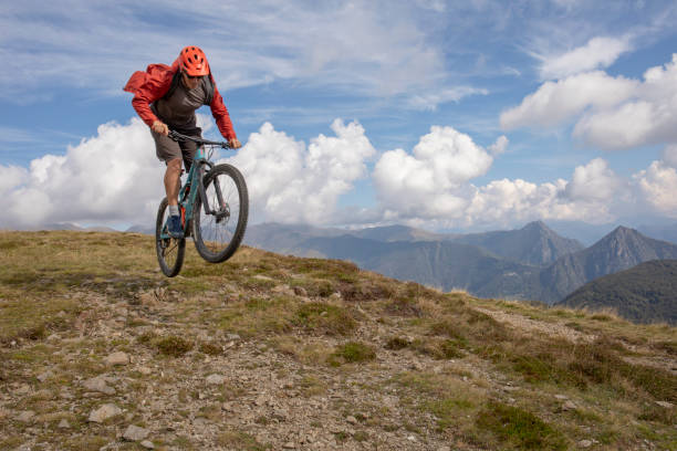 istock Mountain biker gets air off jump on mountain ridge 1351829262