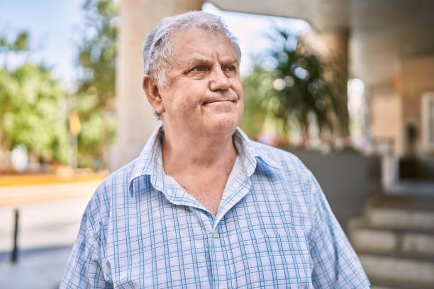 istock Middle age grey-haired man smiling confident walking at street 1351831034