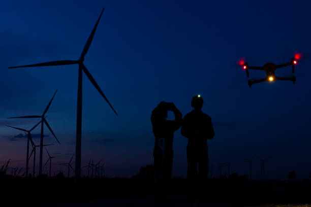 istock Silhouette of a male and female engineers using a drone. 1351831424