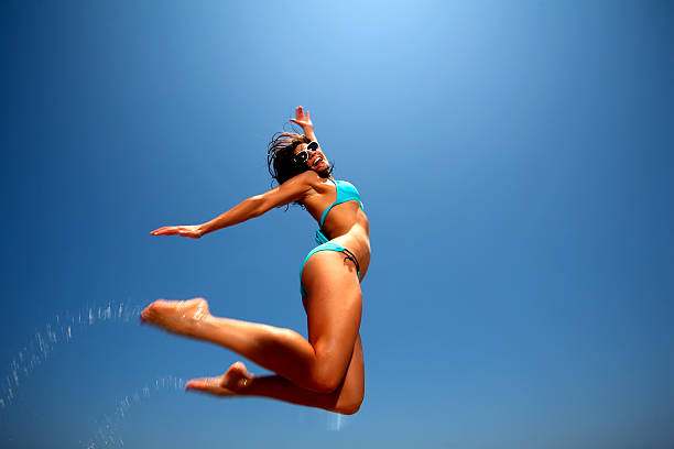 istock Young Brunette Woman in Blue bikini at the beach 135183192
