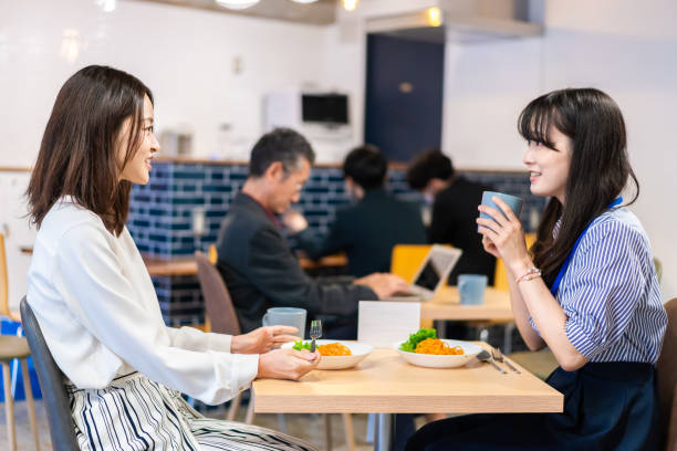 istock Employees eating lunch in the office cafeteria 1351834068