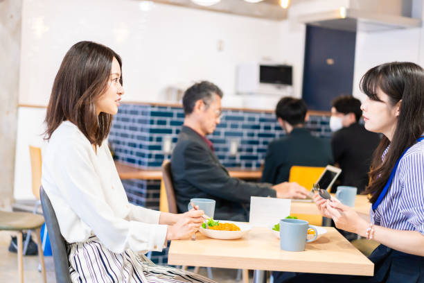istock Employees eating lunch in the office cafeteria 1351834079