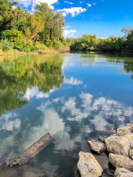 istock River loading ramp with rocks and mirror reflection along Denton Creek – Trinity River near Dallas, Texas, USA 1351834998