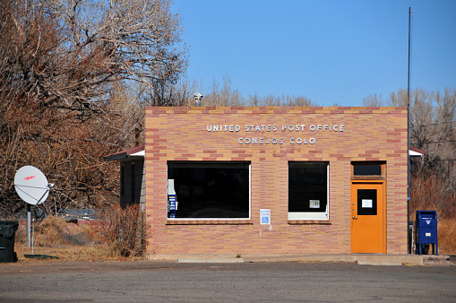 Conejos, Colorado, USA: a modest building of the United States Post Office (USPS) serving rural America ('Conejos' is Castillian for 'rabbits' - County Road.
