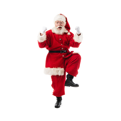 Happy santa claus celebrating holding fists in the air isolated on white background, full length