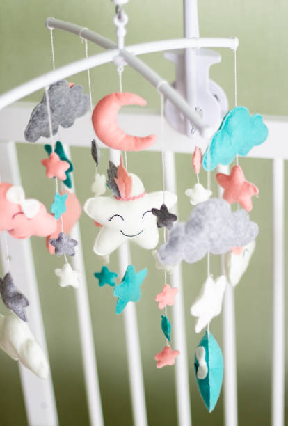 istock Textile soft toys rotate over the baby's crib. mobile for the cradle. 1351836456