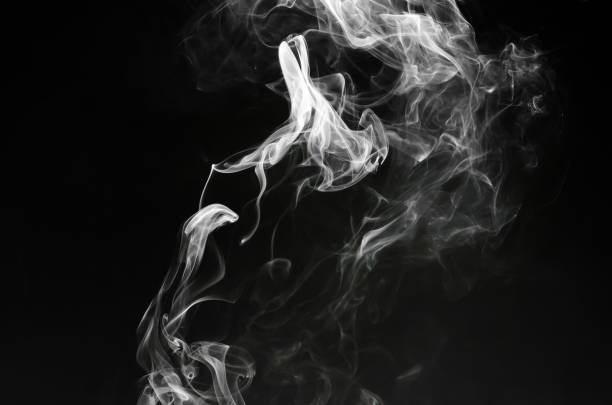 istock abstract fragment movement of white smoke on black background. 1351836584