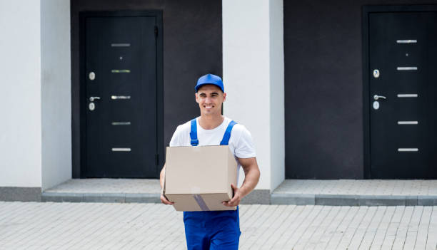 istock Young delivery man hold a cardboard box in his hands 1351837307